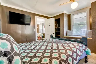 a bedroom with a bed and a flat screen tv at Cincinnati Home Rental with Balcony and Fire Pit! in Cincinnati