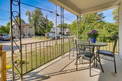a balcony with a table and chairs and a fence at Cincinnati Home Rental with Balcony and Fire Pit! in Cincinnati