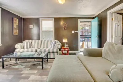 a living room with two couches and a table at Cincinnati Home Rental with Balcony and Fire Pit! in Cincinnati