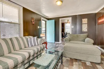 a living room with two couches and a table at Cincinnati Home Rental with Balcony and Fire Pit! in Cincinnati