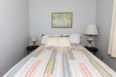 a bedroom with a bed with a colorful bedspread at Bluebirds Road to Happiness in Vermilion