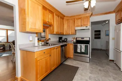 a kitchen with wooden cabinets and stainless steel appliances at Bluebirds Road to Happiness in Vermilion