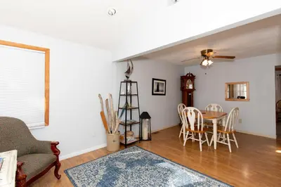 a living room with a table and chairs at Bluebirds Road to Happiness in Vermilion