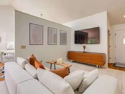 a living room with a white couch and a tv at Upscale Home near Blossom, CVNP, Ski Resorts in Cuyahoga Falls