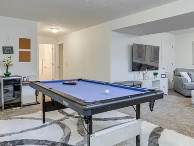 a living room with a pool table in it at Upscale Home near Blossom, CVNP, Ski Resorts in Cuyahoga Falls