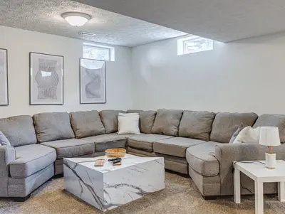 a living room with a couch and a table at Upscale Home near Blossom, CVNP, Ski Resorts in Cuyahoga Falls