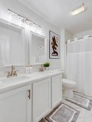 a white bathroom with a sink and a toilet at Upscale Home near Blossom, CVNP, Ski Resorts in Cuyahoga Falls