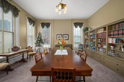 a dining room with a long table and chairs at The Vistula Rose B & B in Toledo