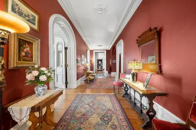 a living room with red walls and wooden floors at The Vistula Rose B & B in Toledo