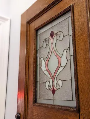 a stained glass window in a wooden door at The Vistula Rose B & B in Toledo