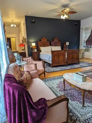 a living room with a bed and a couch at The Vistula Rose B & B in Toledo