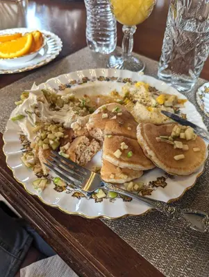 a plate of food on a table with a plate of food at The Vistula Rose B & B in Toledo