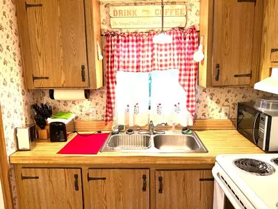 a kitchen counter with a sink and a window at White Caps Motel and RV Park in Port Clinton