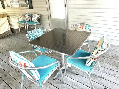 a table and chairs sitting on a porch at White Caps Motel and RV Park in Port Clinton