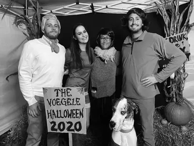 a group of people posing for a picture with a dog at The Voegele Historic Lofts in Mansfield