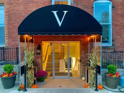 a building with a blue awning with a v sign on it at The Voegele Historic Lofts in Mansfield