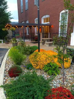 a garden of flowers in front of a building at The Voegele Historic Lofts in Mansfield