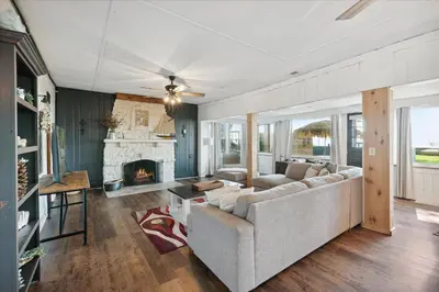 a living room with a couch and a fireplace at Lakefront Family Home/Golf Cart/Beach in Luna Pier