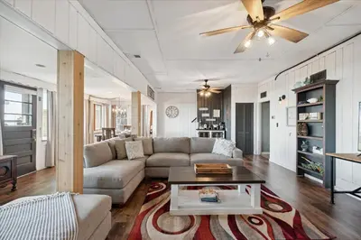 a living room with a couch and a ceiling fan at Lakefront Family Home/Golf Cart/Beach in Luna Pier