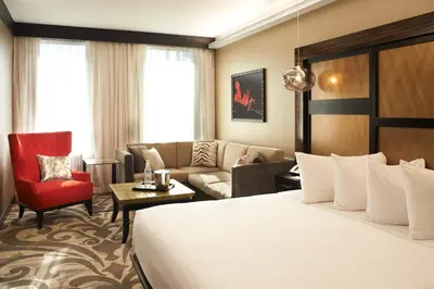 a hotel room with a bed and a couch at Metropolitan at The 9, Autograph Collection in Cleveland