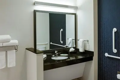 a bathroom with a sink and a large mirror at Fairfield Inn & Suites by Marriott Columbus Airport in Columbus