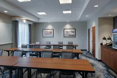 a conference room with tables and chairs in it at Fairfield Inn & Suites by Marriott Columbus Airport in Columbus