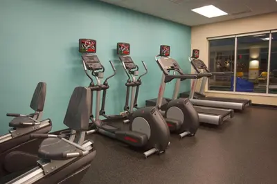a gym with several cardio machines in a room at Fairfield Inn & Suites by Marriott Columbus Airport in Columbus