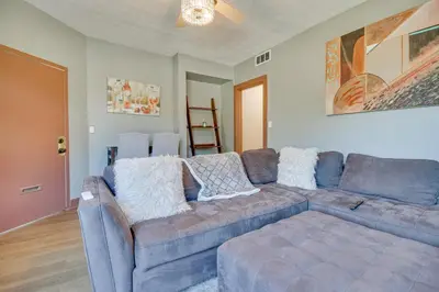 a living room with a blue couch and a table at Jetted Tub Dayton Condo, 2 Mi to Oregon District in Dayton