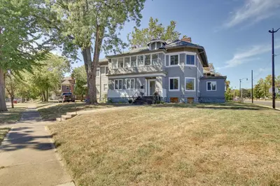 a large white house with a large yard at Jetted Tub Dayton Condo, 2 Mi to Oregon District in Dayton