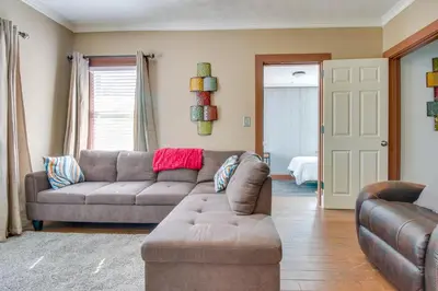 a living room with a couch and a chair at Sunny and Spacious Dayton Condo about 1 Mi to Downtown! in Dayton