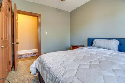 a bedroom with a large bed and a blue door at Sunny and Spacious Dayton Condo about 1 Mi to Downtown! in Dayton