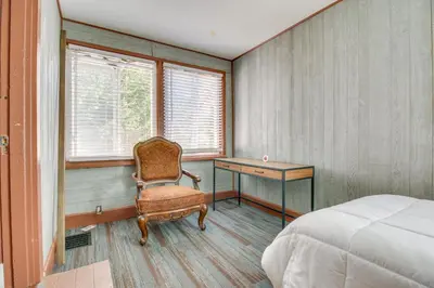 a bedroom with a bed and a desk and a chair at Sunny and Spacious Dayton Condo about 1 Mi to Downtown! in Dayton