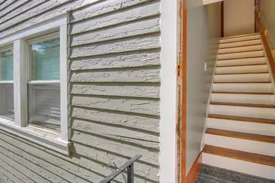 a wooden house with a window and a staircase at Sunny and Spacious Dayton Condo about 1 Mi to Downtown! in Dayton