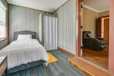 a bedroom with a bed and a chair in it at Sunny and Spacious Dayton Condo about 1 Mi to Downtown! in Dayton