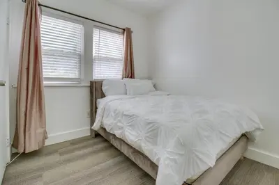a bedroom with a white bed and a window at Convenient Dayton Vacation Rental Near Downtown! in Dayton