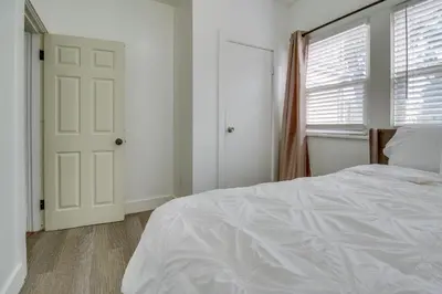 a white bedroom with a bed and a window at Convenient Dayton Vacation Rental Near Downtown! in Dayton