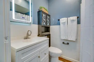 a bathroom with a toilet and a sink and a mirror at Convenient Dayton Vacation Rental Near Downtown! in Dayton