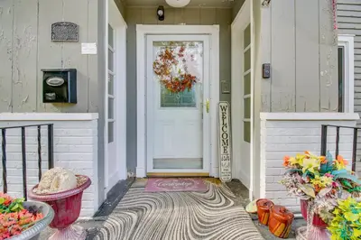 a front door of a house with flowers on the porch at Convenient Dayton Vacation Rental Near Downtown! in Dayton