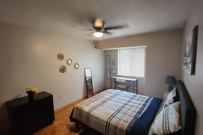 a bedroom with a bed and a ceiling fan at Tastefully Furnished 3bd @Euclid in Euclid