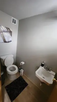 a bathroom with a toilet and a sink at Tastefully Furnished 3bd @Euclid in Euclid