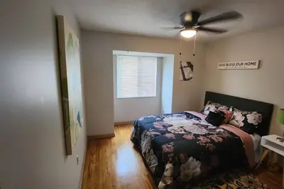 a bedroom with a bed and a ceiling fan at Tastefully Furnished 3bd @Euclid in Euclid