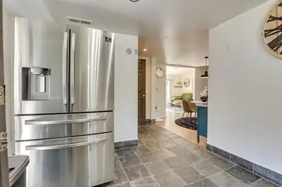 a kitchen with a stainless steel refrigerator at Modern Northfield Cottage with Yard! in Northfield