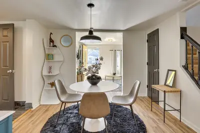 a dining room with a white table and chairs at Modern Northfield Cottage with Yard! in Northfield