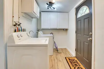 a small kitchen with a sink and a door at Modern Northfield Cottage with Yard! in Northfield