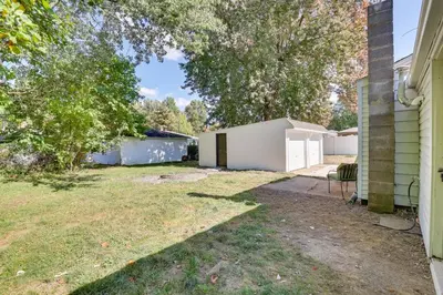 a yard with a house and a driveway at Modern Northfield Cottage with Yard! in Northfield