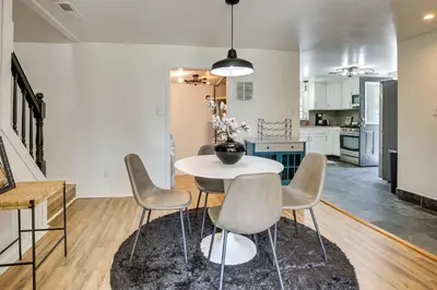 a kitchen and dining room with a white table and chairs at Modern Northfield Cottage with Yard! in Northfield