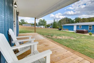 a porch with two white chairs on a house at Hillsboro Hideaway with Private Hot Tub and Bunkhouse! in Hillsboro