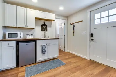 a kitchen with white cabinets and a microwave at Hillsboro Hideaway with Private Hot Tub and Bunkhouse! in Hillsboro