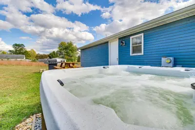 a hot tub in a yard next to a house at Hillsboro Hideaway with Private Hot Tub and Bunkhouse! in Hillsboro