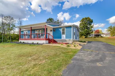 a home with a blue and red house at Hillsboro Hideaway with Private Hot Tub and Bunkhouse! in Hillsboro